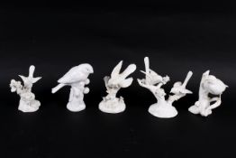Five white porcelain figures modelled as birds.