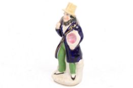 A 19th century Staffordshire pottery figure of 'The Hat Seller'.