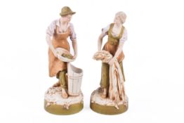 A pair of Dux ceramic figures.