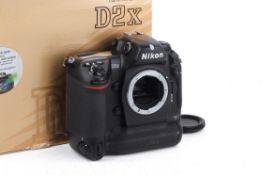 A Nikon D2X Digital SLR Camera Body. With makers box. Powers on, shutter working.