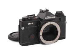 An Olympus OM-4 35mm SLR Camera Body. Black. Serial number 1074713. Untested.