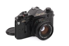 A Canon A1 35mm SLR Camera. Black. Serial number 2258523. With a Canon 50mm f1.8 lens. Untested.