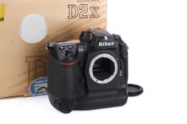 A Nikon D2X Digital SLR Camera Body. With makers box. Powers on, shutter working.