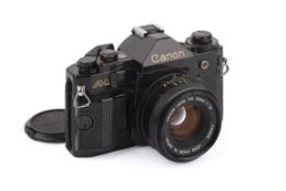 A Canon A1 35mm SLR Camera. Black, Serial number 2006296. With a Canon FD 50mm f1.8 lens. Untested.