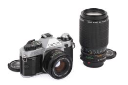 A Canon AE1 Program 35mm SLR Camera Outfit. Chrome, Serial number 3701829.