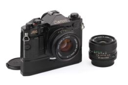 A Canon A1 35mm SLR Camera Outfit. Black, Serial number 458449. With two lenses; a Canon FD 50mm f1.