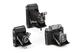 Three Zeiss Ikon Super Ikonta Folding Rangefinder Cameras.