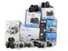 A collection of Nikon and Minolta cameras. All used with makers boxes.