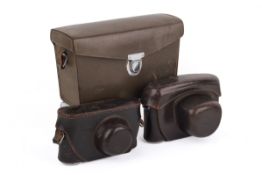 Three Leitz camera cases.