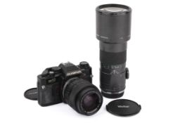 An Olympus OM40 Program 35mm SLR camera outfit. Black. Serial number 1158901.