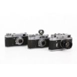 A group of three assorted Soviet rangefinder film cameras.