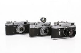 A group of three assorted Soviet rangefinder film cameras.