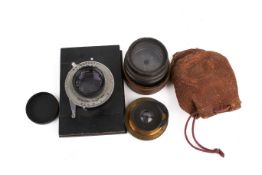 A group of three assorted vintage camera lenses.