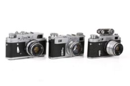 A group of three assorted Soviet rangefinder film cameras.