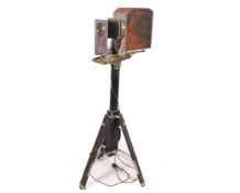 A vintage 'magic lantern' lamp with wooden tripod. Fitted with a 240v light.