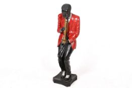 A fibre glass figure modelled as a jazz trumpeter. Raised on a plinth base.