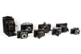 A collection of eight assorted vintage folding bellows film cameras.