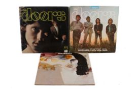 A group of three assoted The Doors LP vinyl records.