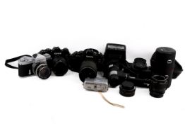 A collection of 35mm cameras and lenses to include two Konica FT -1 cameras a Nikon light touch