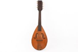 A vintage eight string mandolin. Having apear shaped body with F holes and a slightly curved back.