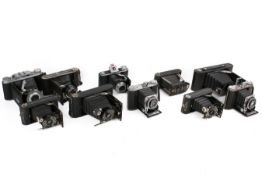 A collection of ten assorted vintage folding bellows film cameras.