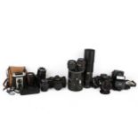 A group of assorted vintage film cameras.