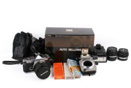 An Olympus OM-2N 35mm film camera outfit.