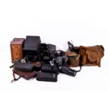 Box of assorted film cameras and accessories. Including a mahogany cased, folding, etc.