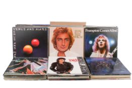 A collection of assorted vinyl LP records, mostly rock and pop,