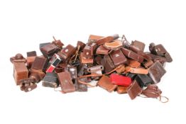 A large collection of assorted vintage mostly leather camera carry cases.