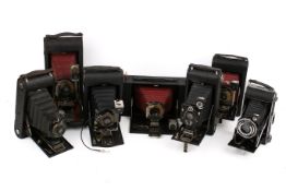 A collection of seven assorted vintage folding bellows film cameras