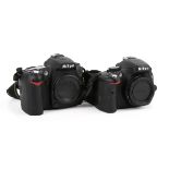 Two Nikon digital SLR camera bodies.