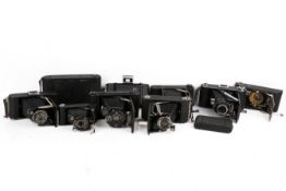 A collection of ten assorted vintage folding bellows film cameras.