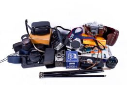 A box of assorted vintage film cameras and photographic accessories.