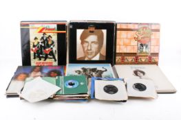 A collection of assorted vinyl LP and 7 inch single records.