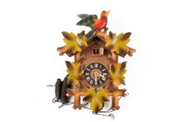 A Mid 20th century West German carved wood cuckoo clock. Having two weights. H41cm.