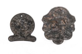Two cast iron plaques, with lion motifs.