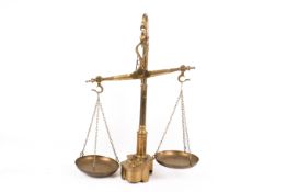 A vintage set of solid brass balance scales and weights.