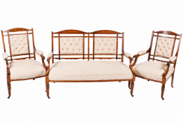 An Edwardian salon suite comprising a sofa and two matching elbow chairs.