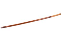 A vintage walking cane with poker work decoration, possibly Russian.