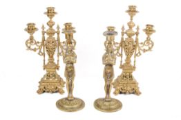 Two pairs of brass candlesticks.