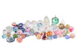 A large collection of glass paperweights. Including examples by Dan Afron, Caithness, etc.