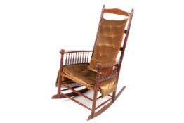 A Victorian mahogany button back rocker chair.