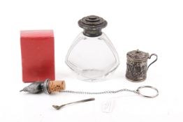 A Chinese white metal condiment pot, and a silver lidded scent bottle.