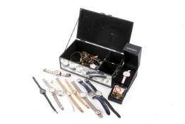 A group of ladies' costume wristwatches in a mirrored jewellery box.