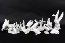 A collection of Lladro and Nao figurines of geese.