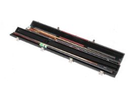 Two boxed snooker cues.
