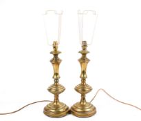 A pair of brass table lamp bases.