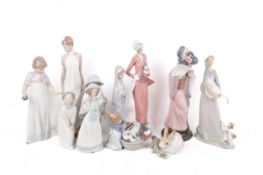 A collection of Lladro and Nao figurines. Modelled as children, women, a rabbit, puppies, etc.