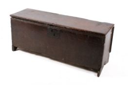 A large 18th century carved oak six plank coffer. Raised on stile supports.